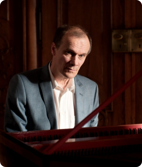 Lad at Harpsichord looking at camera